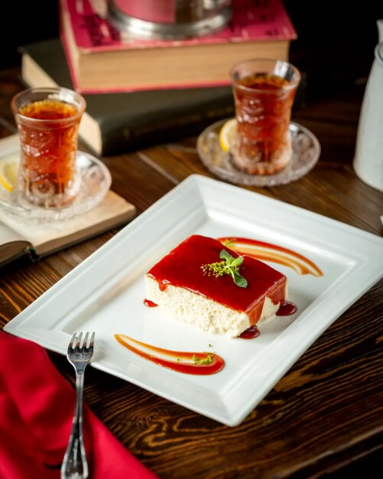 Caramel syrup poured cottage cheese cake and a cup of tea